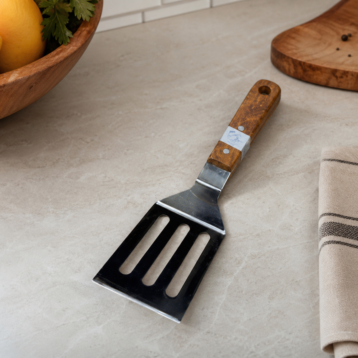 Stainless steel slotted turner with silver blade and brown wooden handle