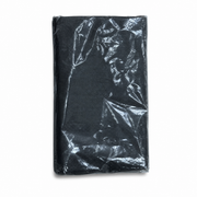 Black textile kitchen apron, shown folded and sealed in clear wrap on a white background