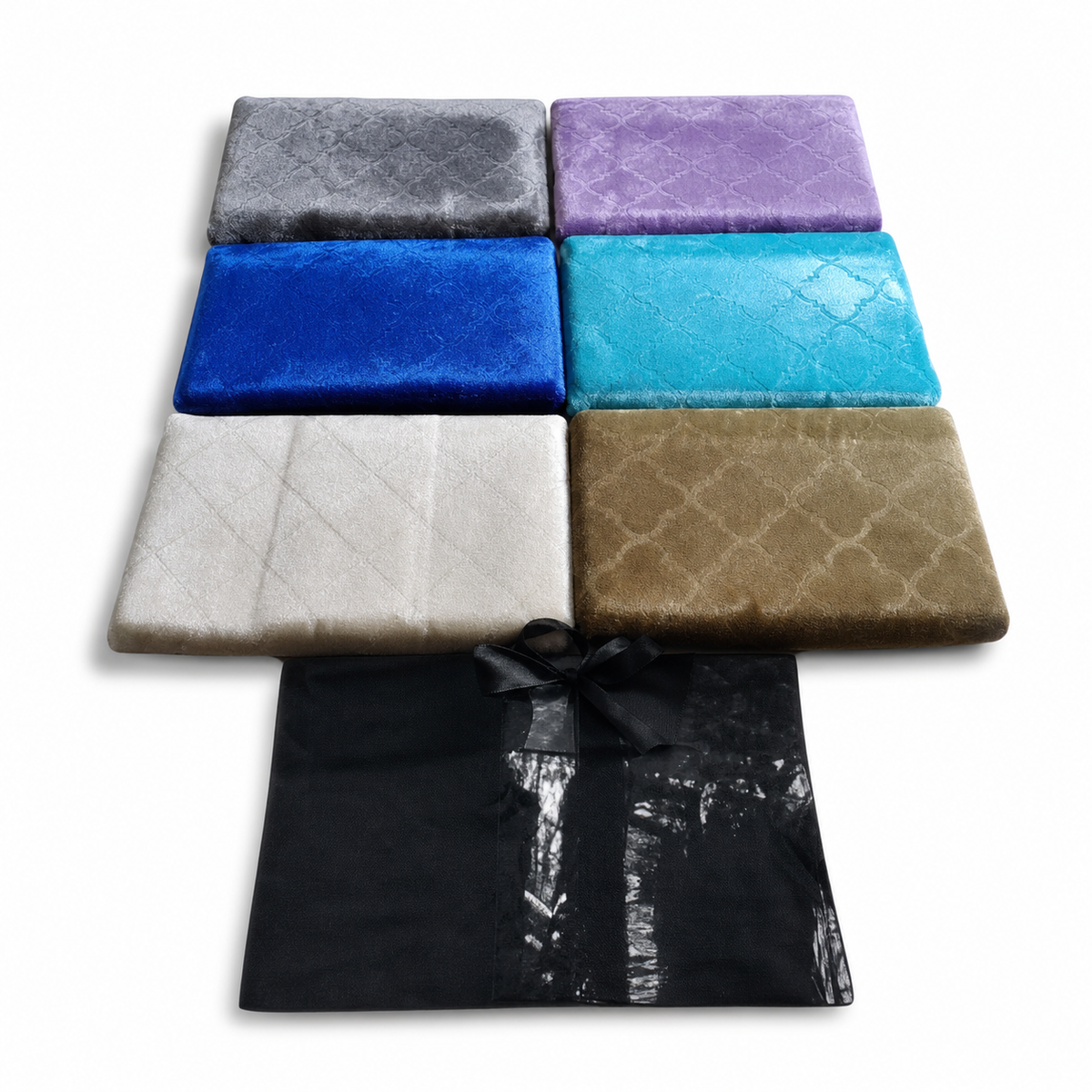 Six folded quilted plush prayer mats in grey, lilac, blue, turquoise, cream and olive, with a black carry bag
