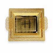 Two nested gold-tone serving trays with pebbled rims, openwork filigree handles and an engraved centre panel