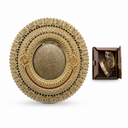 Nested round gold-tone filigree serving trays with a calligraphy centre, beside a boxed ornament