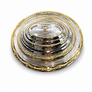 Nested silver serving trays with gold filigree rims under a domed cover with a gold loop handle