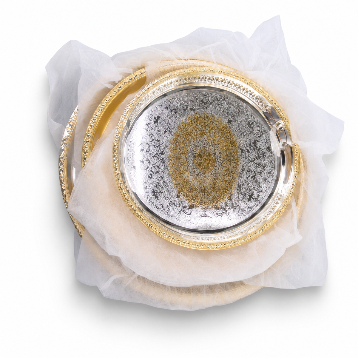 Round silver serving tray with gold arabesque centre and gold filigree rim, wrapped in white tissue