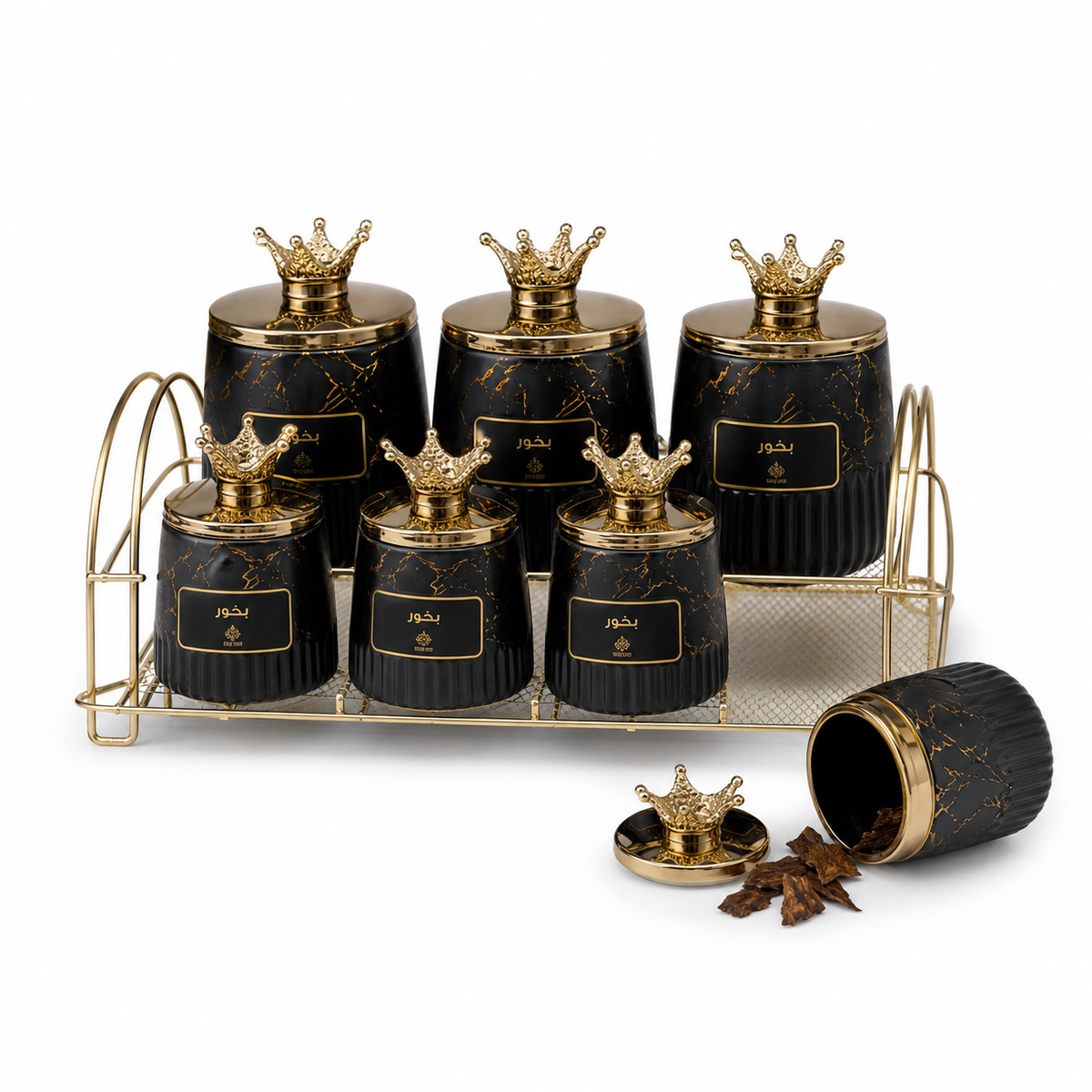Black jars with gold marbling and crown lids on a gold-tone wire stand, one jar open beside it