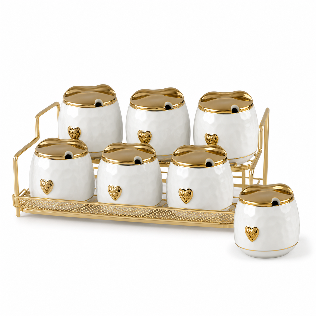 Seven white ceramic canisters with wavy-edged gold lids and gold heart emblems on a gold-tone rack