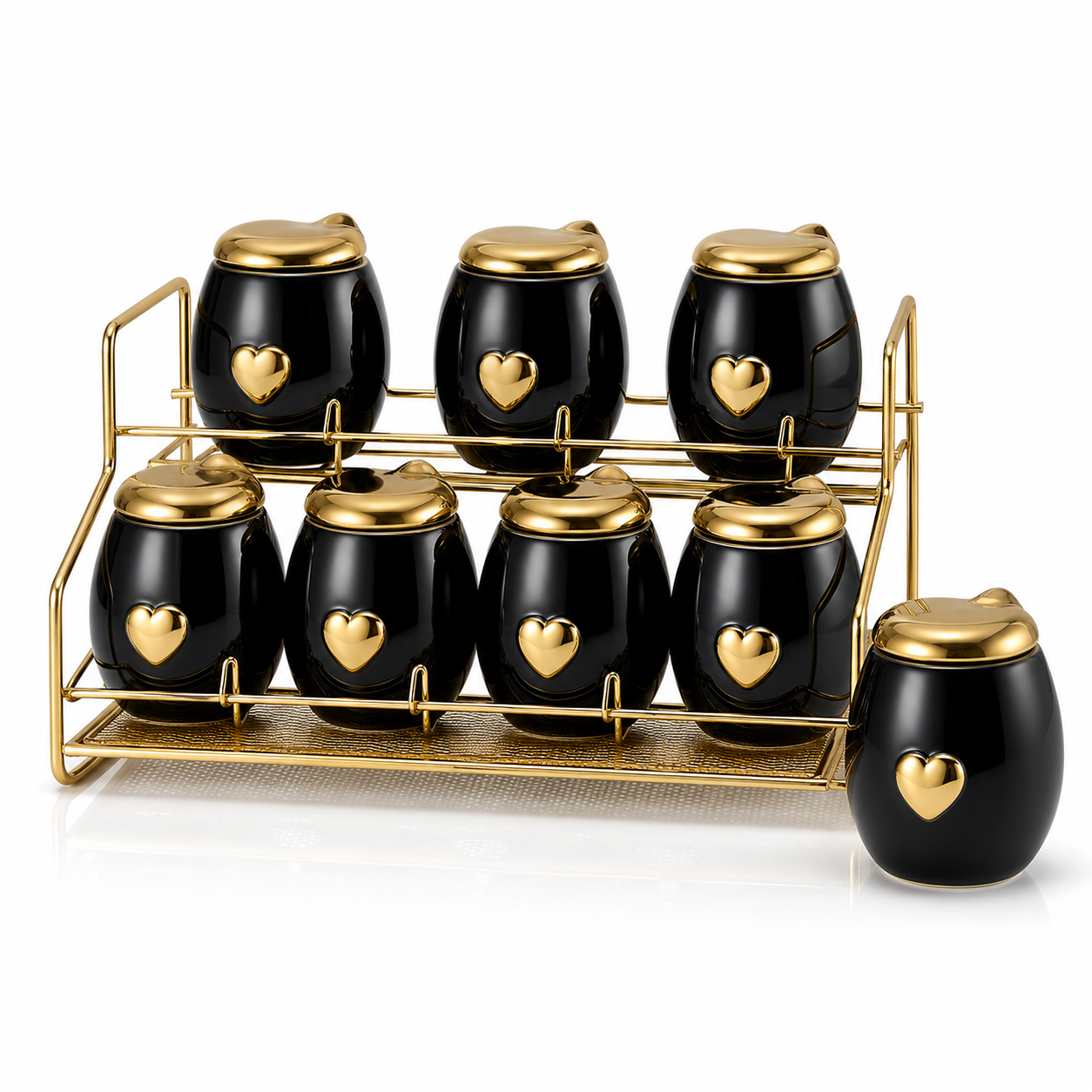 Black and gold ceramic seasoning canister set on a gold-tone rack