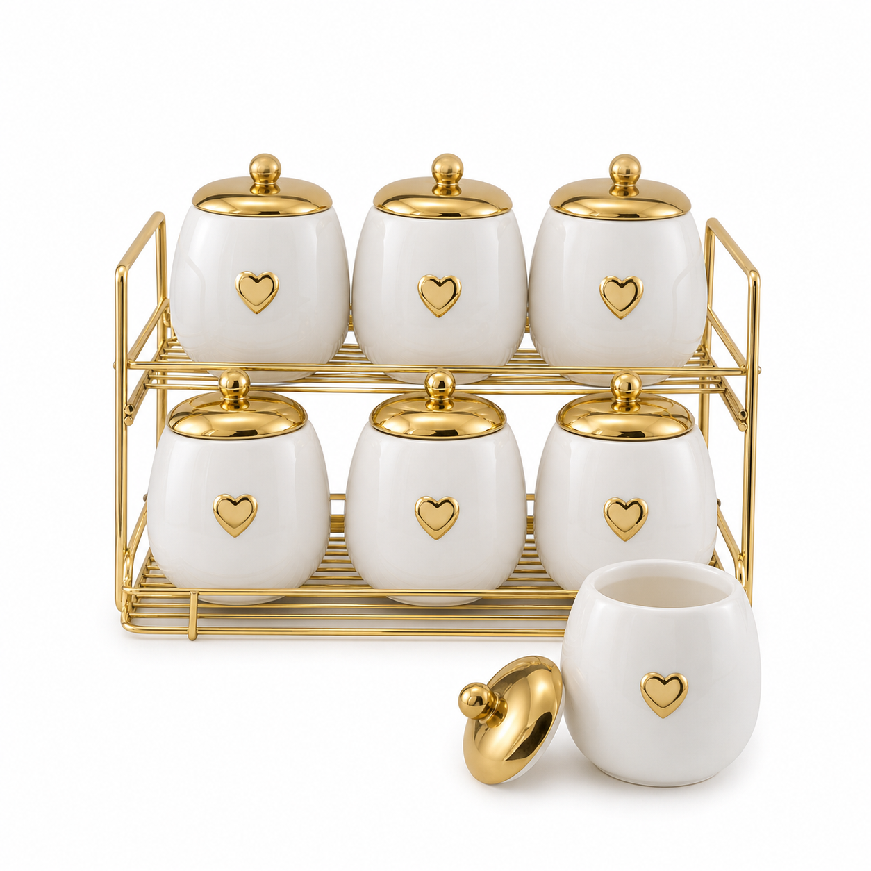 Seven white canisters with domed gold ball-knob lids and gold hearts on a two-tier gold-tone rack