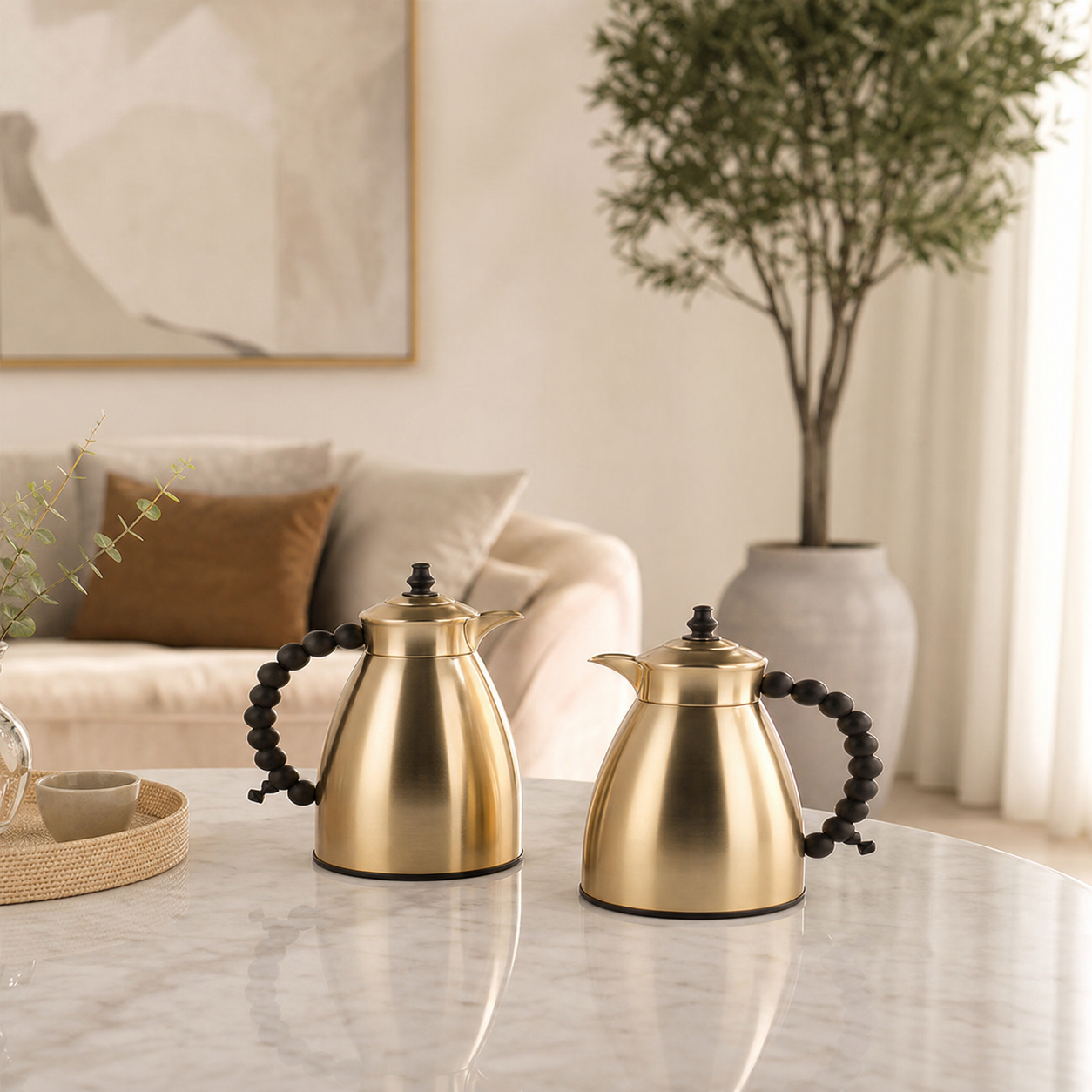 Pair of gold flasks with black beaded handles on a marble table in a living room