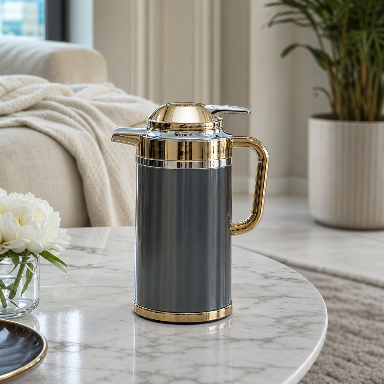 Grey insulated flask with smooth gloss body, gold-tone lid, handle and base ring, on marble