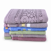 Stack of six terry bath towels in lilac, taupe, blue, sage green and plum with woven border bands