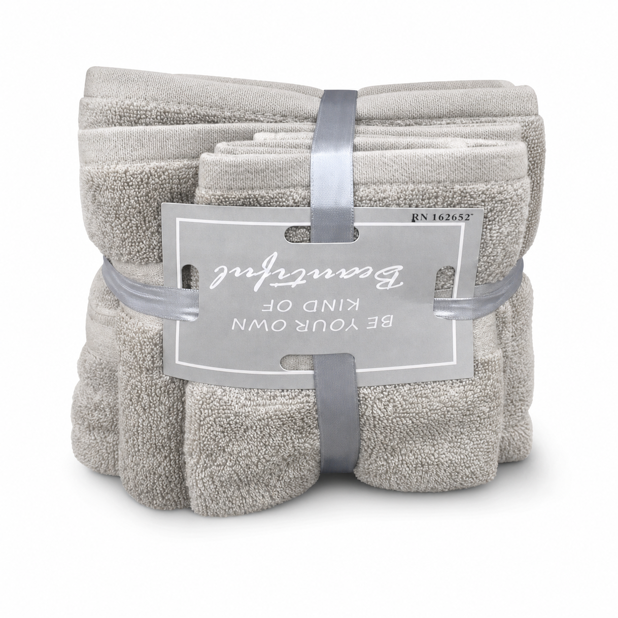 Three-piece beige terry towel set, folded and banded with a grey ribbon, on a white background