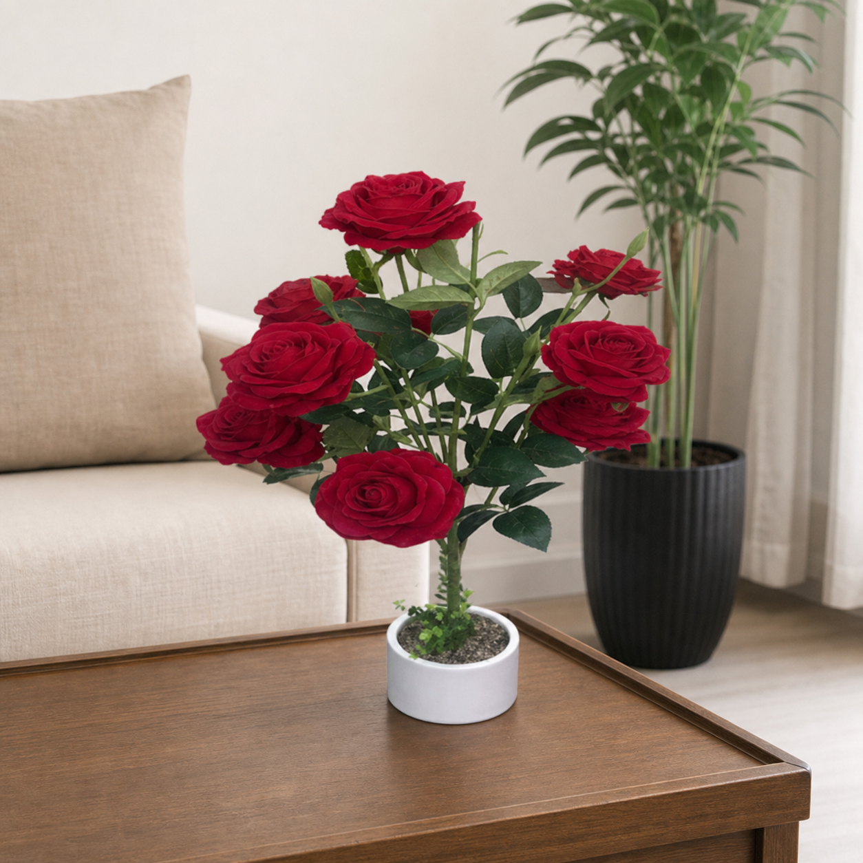 Red artificial roses arranged in a white vase