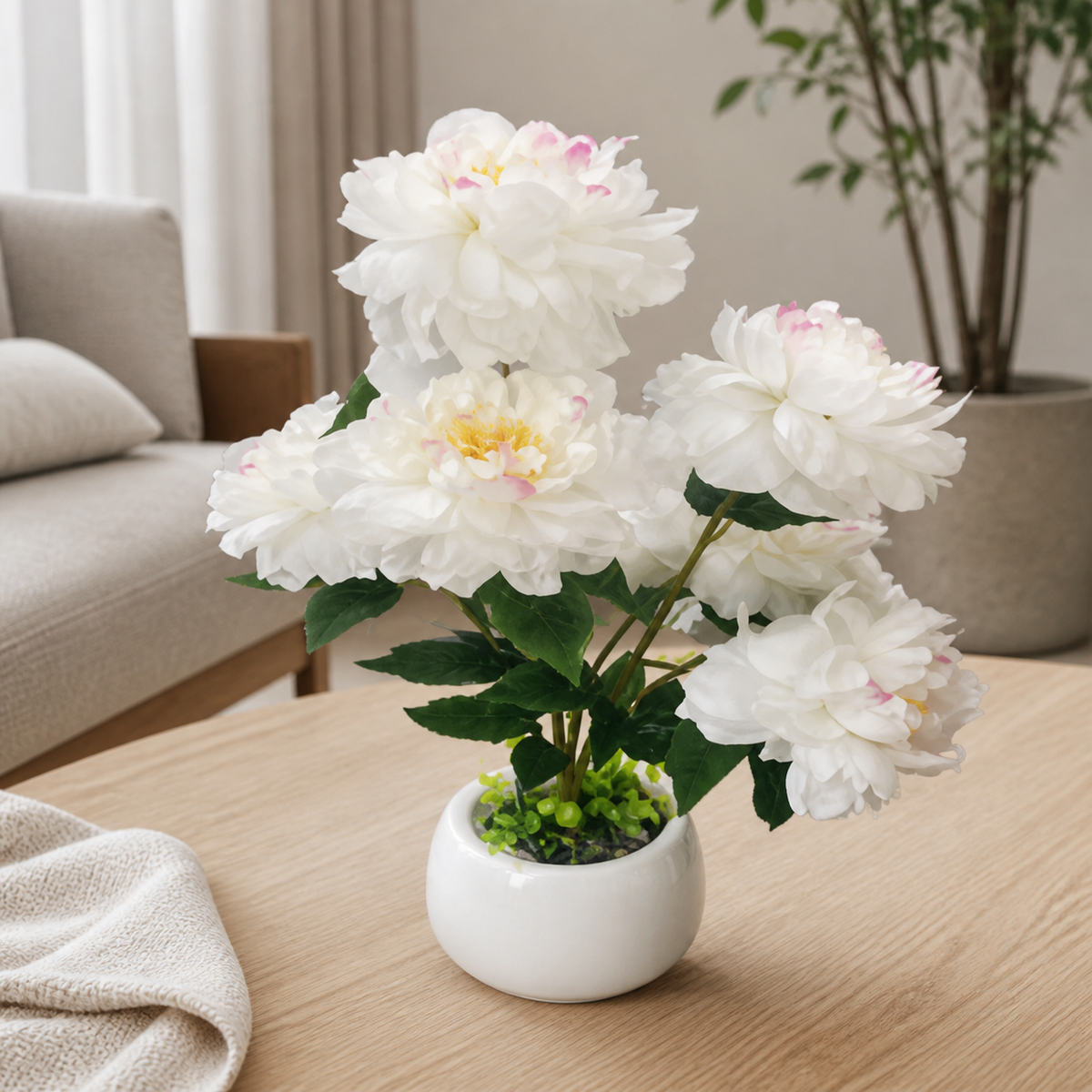 White and ivory artificial peonies arranged in a white vase