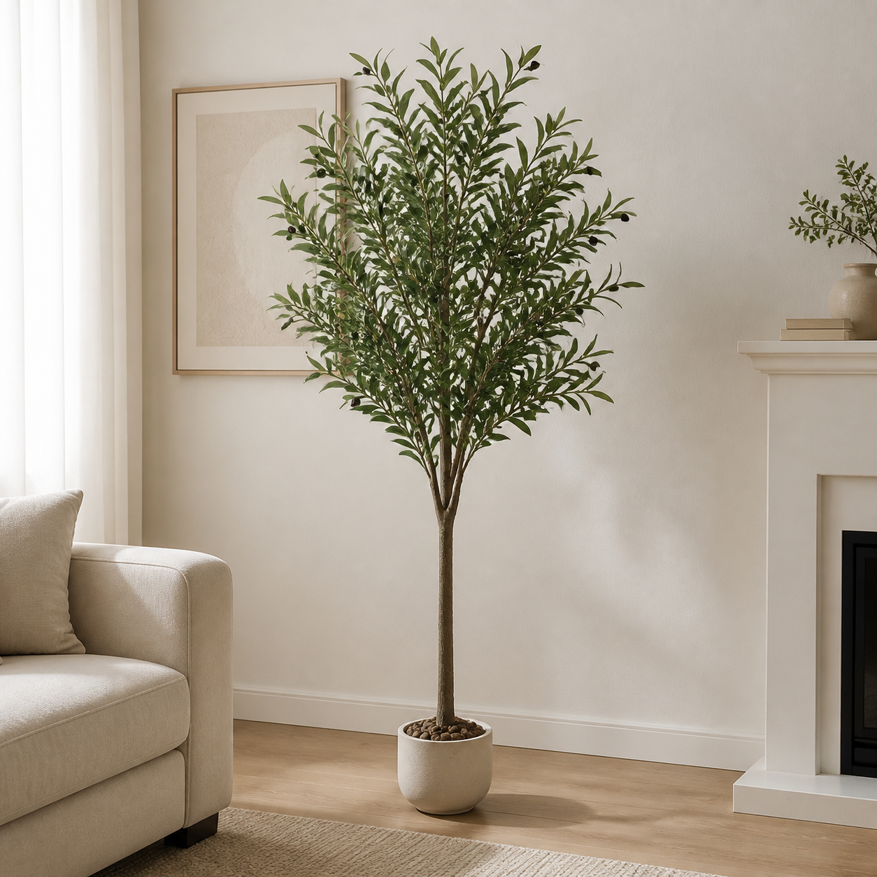 Artificial olive tree in a round beige planter beside a sofa and fireplace in a living room