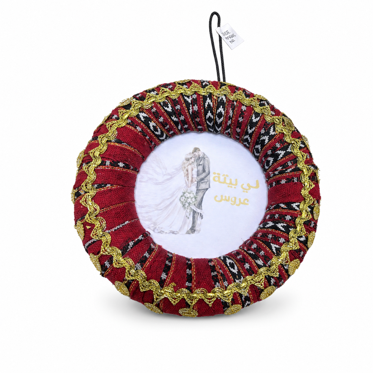 Round pleated red, black and white fabric rosette with gold trim and printed bride-and-groom centre