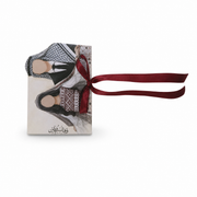 Printed wedding favor panel with a couple in traditional dress, Arabic calligraphy and a burgundy ribbon