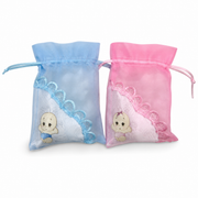 Light pink and light blue organza pouches with a baby motif and lace trim