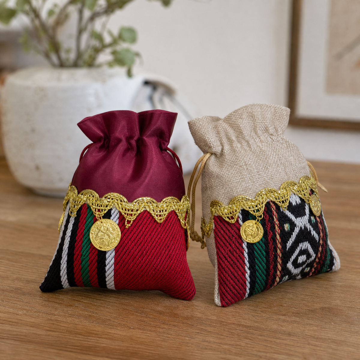 Embroidered fabric favor pouches in red and beige with gold-tone coin and trim