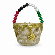 Cream plaited candy basket with gold-tone braid trim, beaded handle and gold coin charm