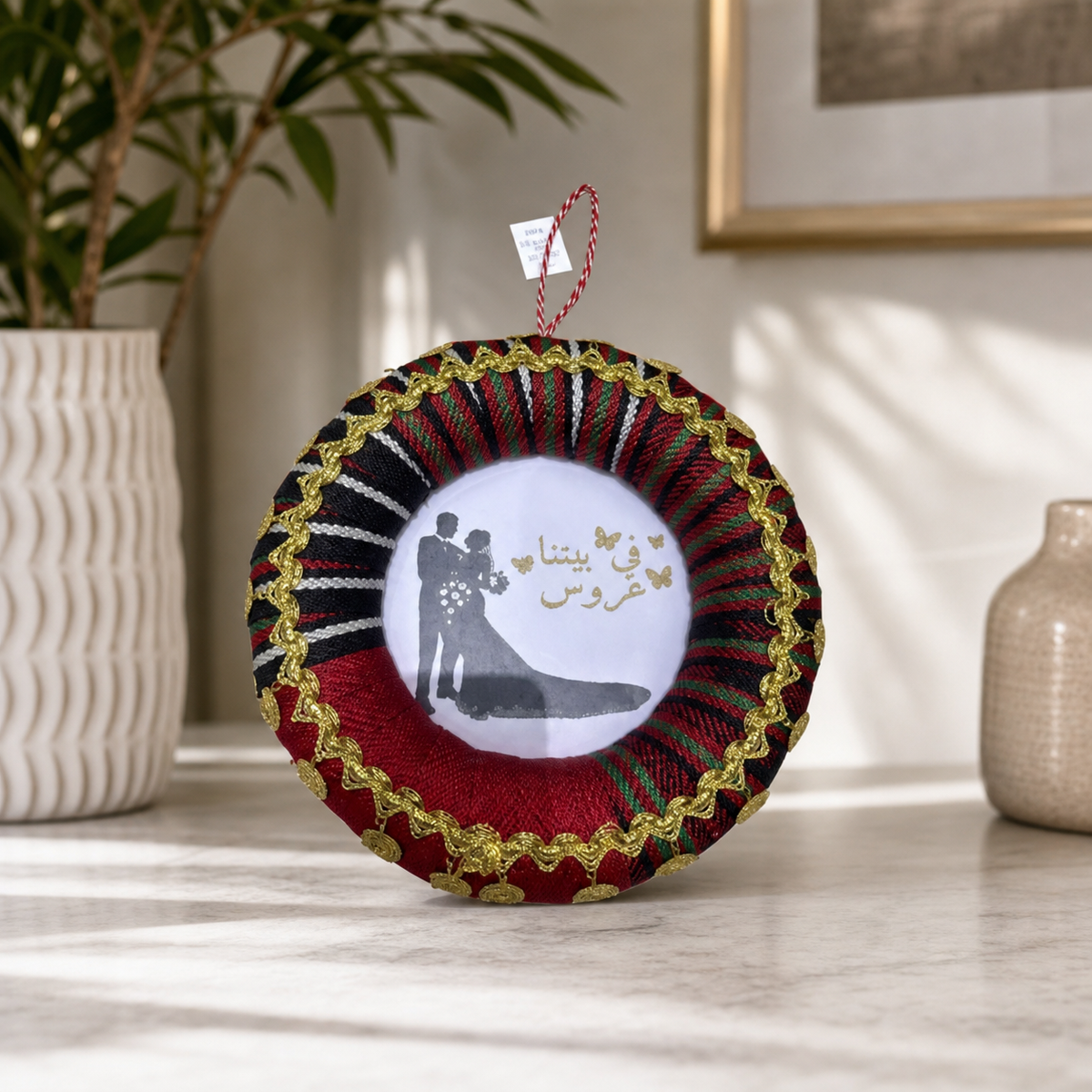Wedding rosette with printed bride-and-groom centre standing on a marble surface