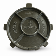 Round dark grey cast metal tortilla press top plate with embossed lettering, on white background