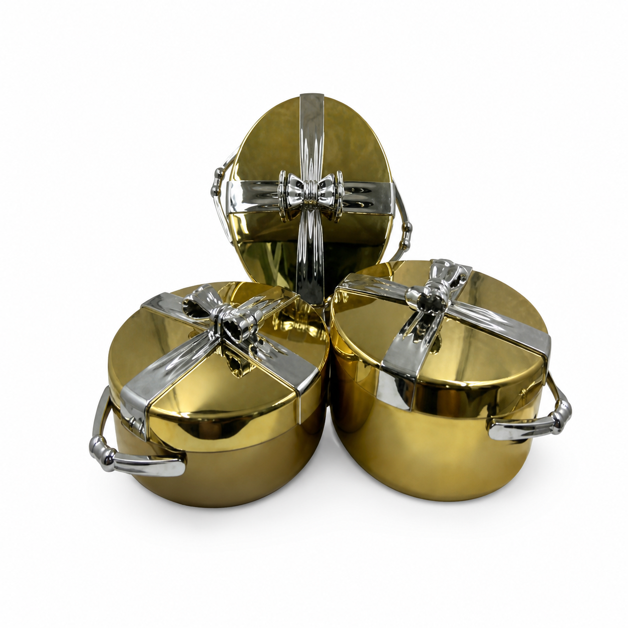 Three gold-tone casserole food warmers with silver ribbon-bow lids and silver handles