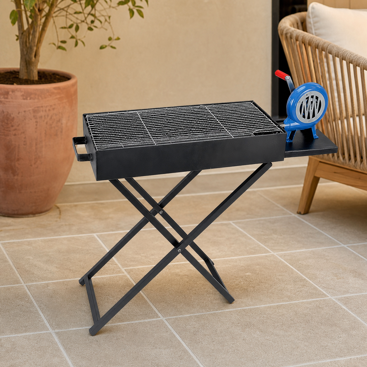 Black portable folding charcoal BBQ grill with blue air blower on X-frame