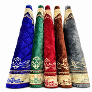Five rolled plush prayer mats in blue, green, red, brown and grey