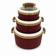 Three nested deep red serving pots with white rims and gold braided bands