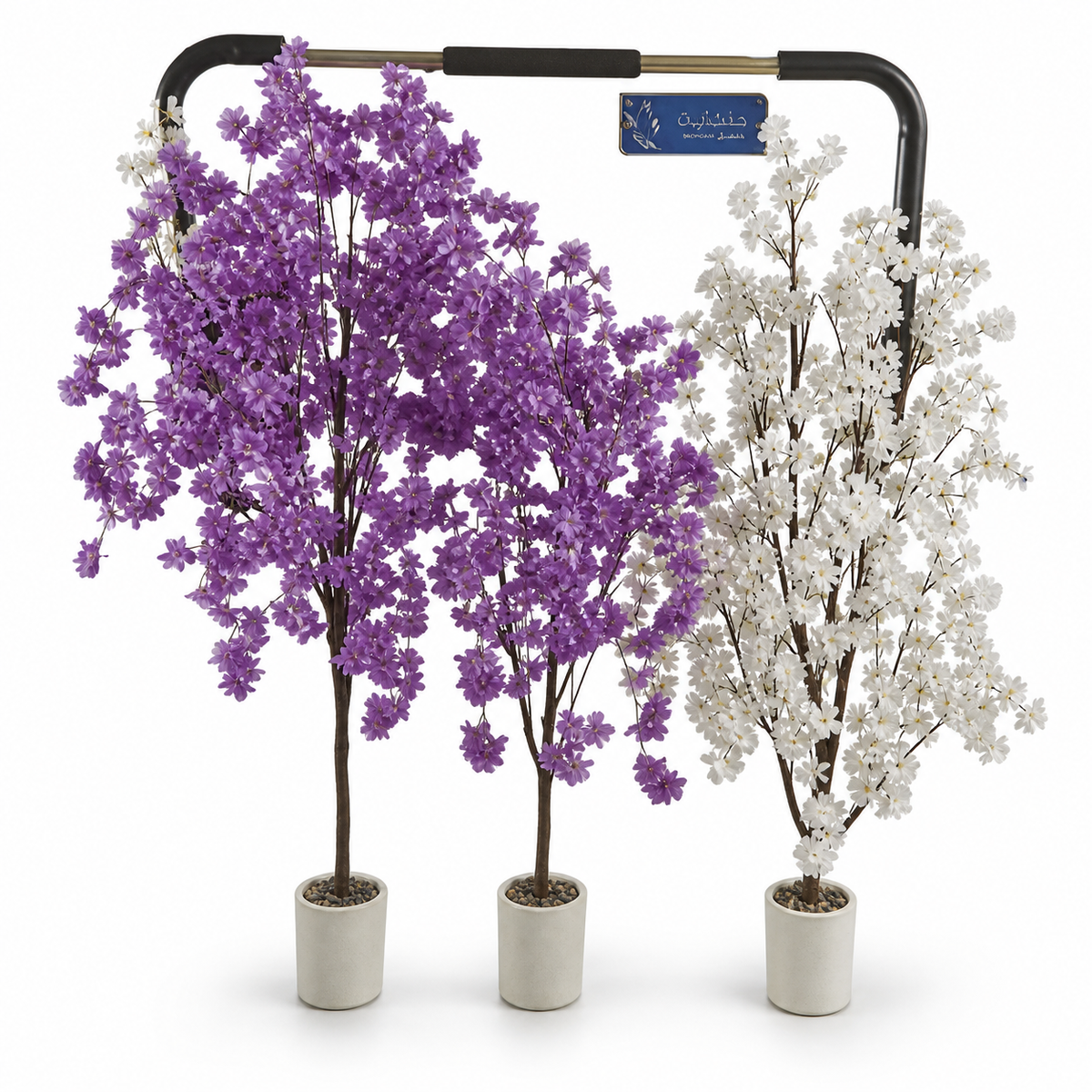 Two purple artificial blossom trees and one white blossom tree in cream pots on a shop display rail