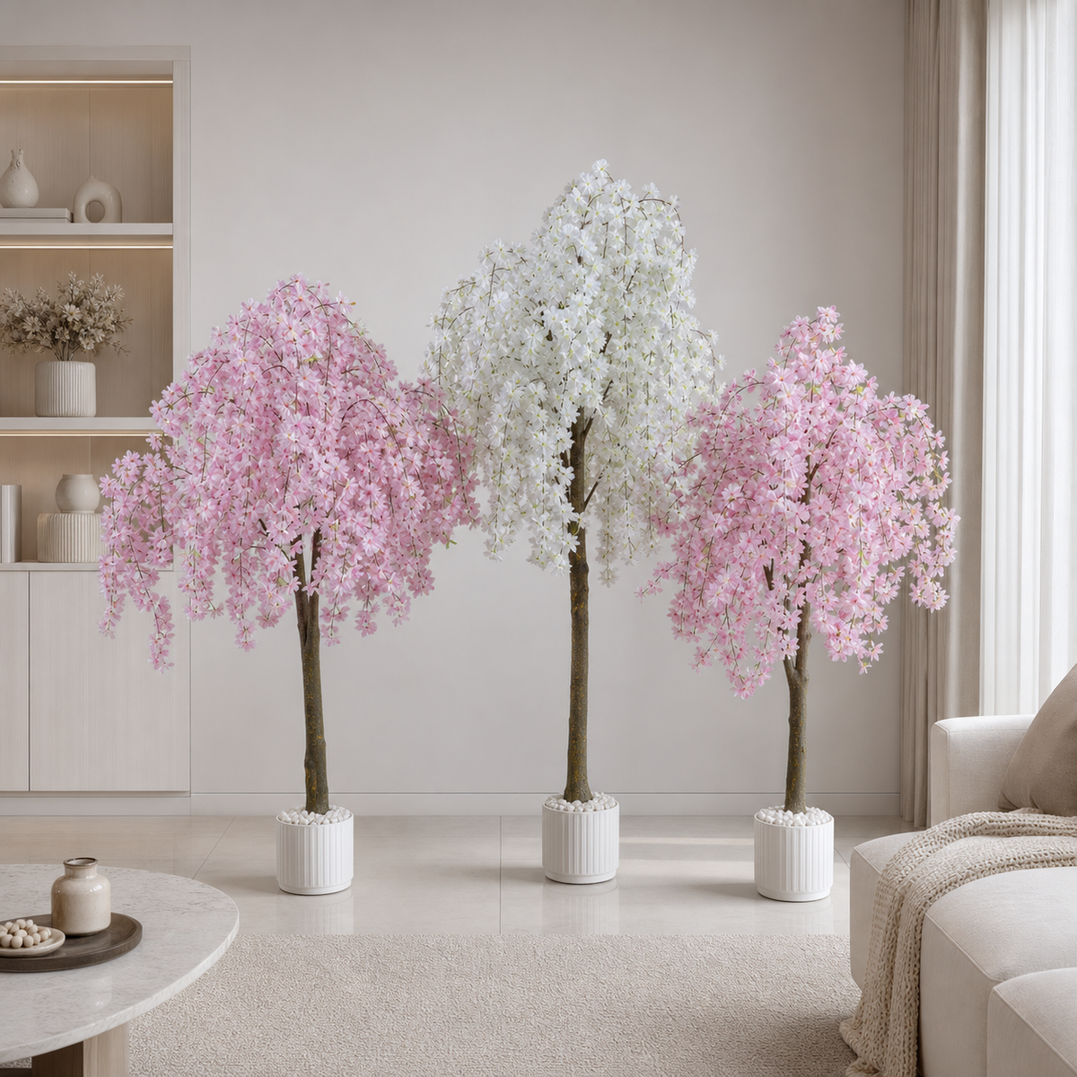 Artificial cherry blossom trees in pink and white standing in a bright, neutral living room