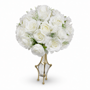 White artificial rose posy in a clear faceted vessel held by a gold-tone frame on ball feet