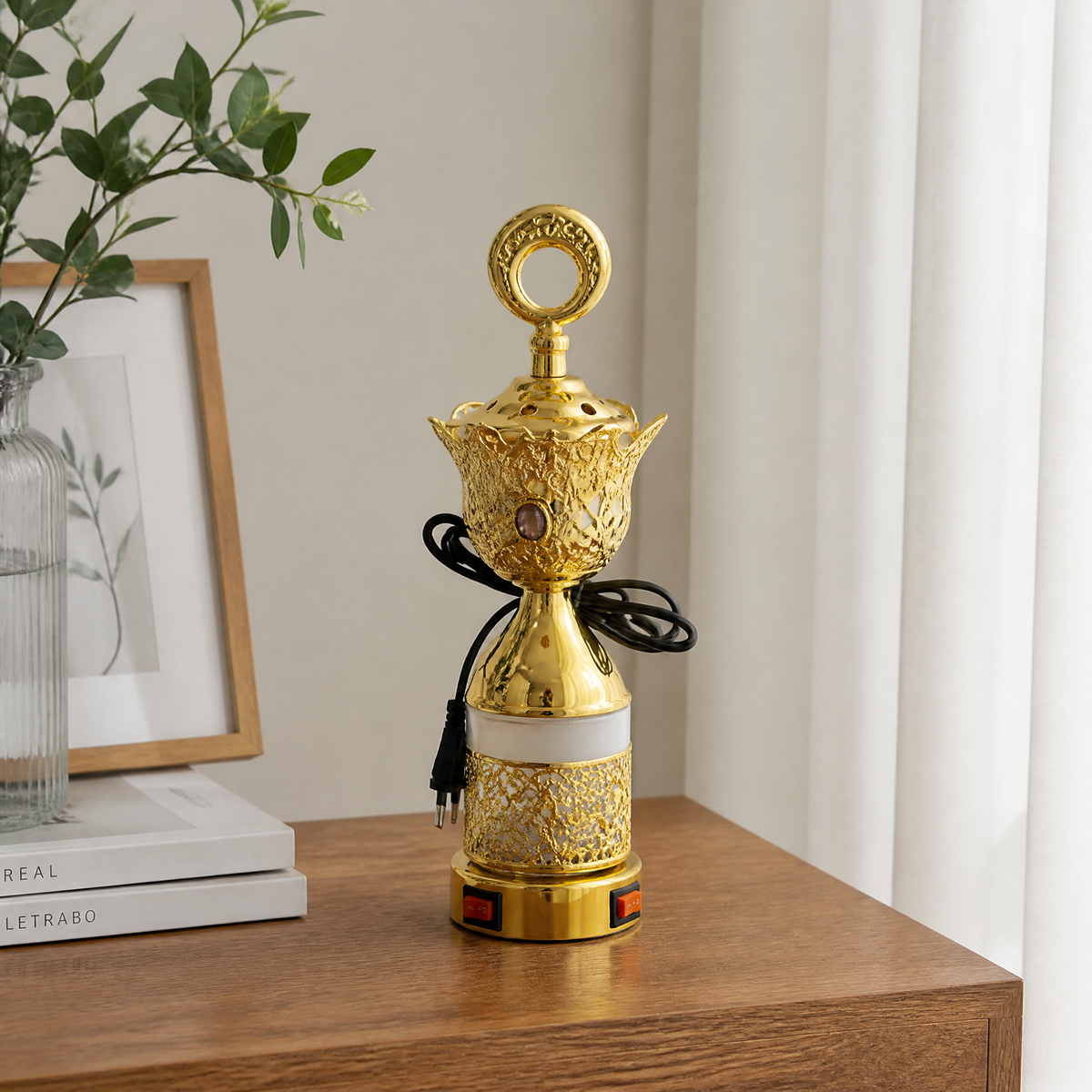Gold and white electric incense burner with ring finial on a wooden sideboard
