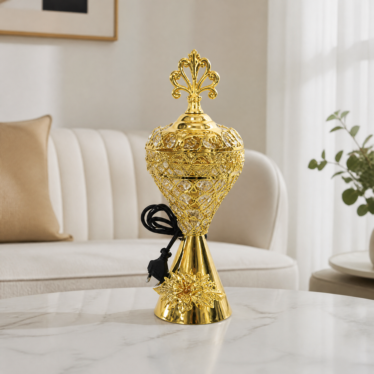 Gold electric incense burner with ornate finial and round base