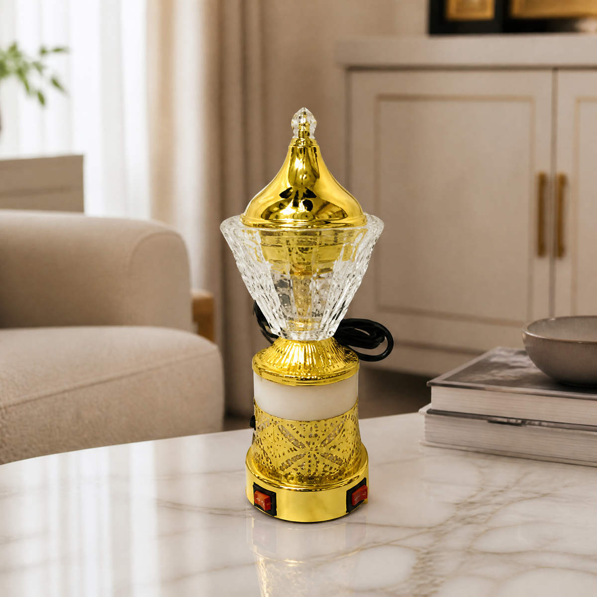 Clear-cone electric incense burner with gold dome lid on a marble table
