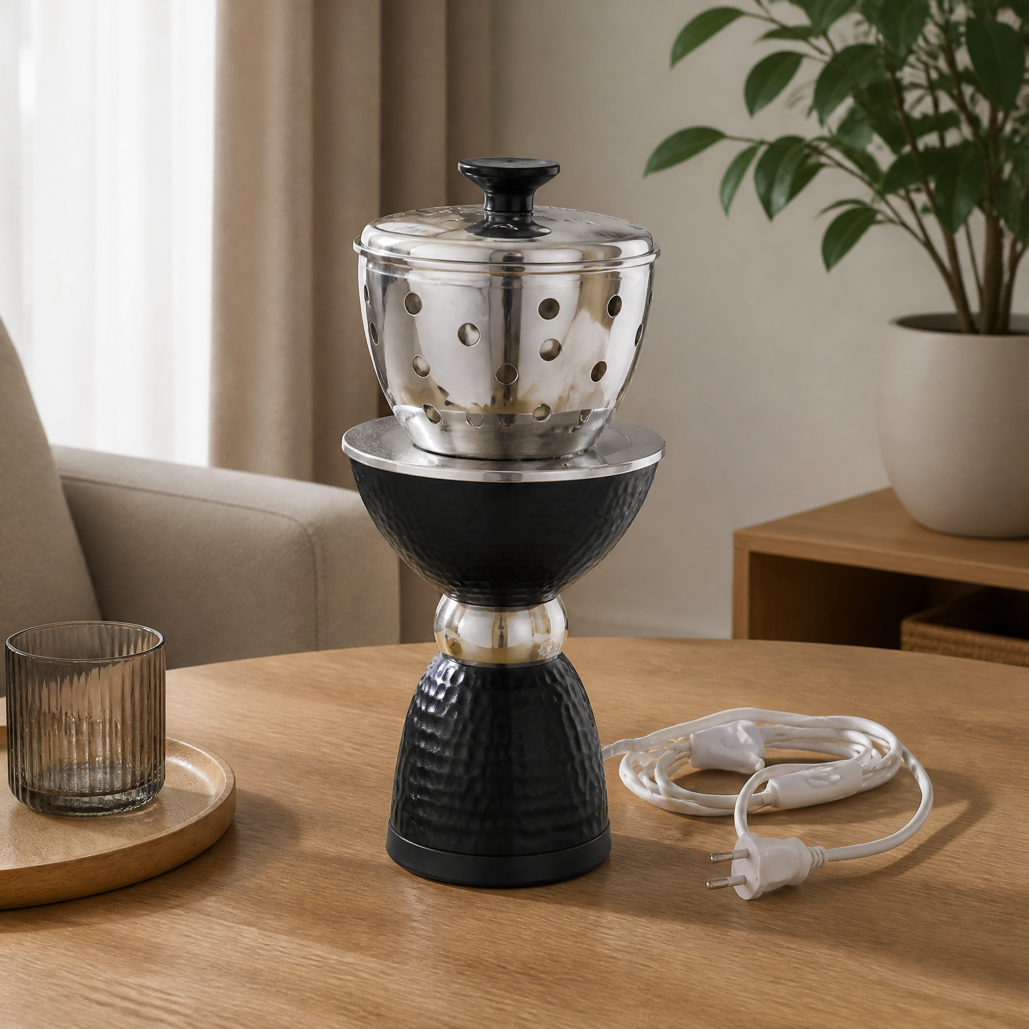 Black and silver electric incense burner with a perforated top