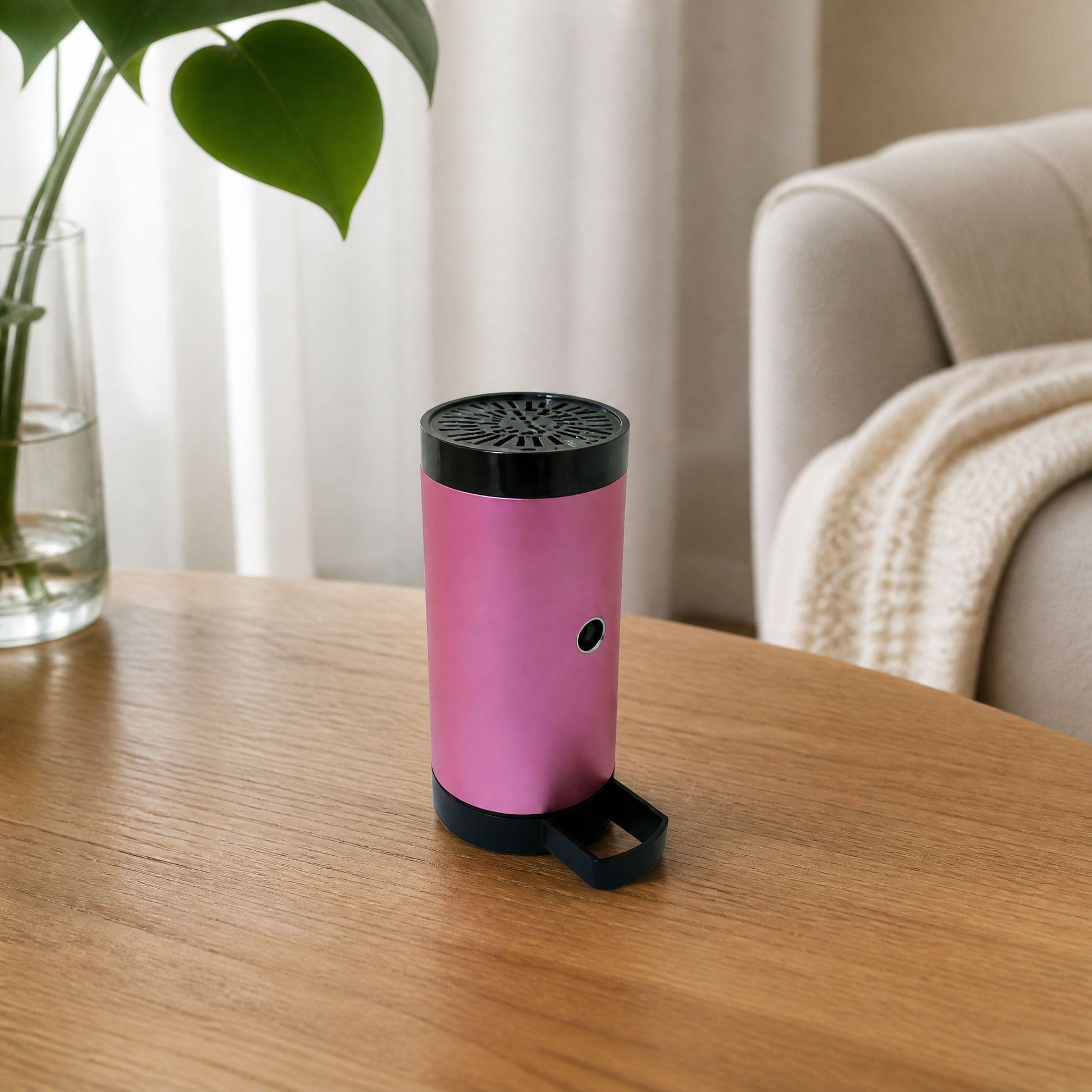 Small pink cylindrical device with a perforated top