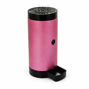 Small pink cylindrical device with a perforated top