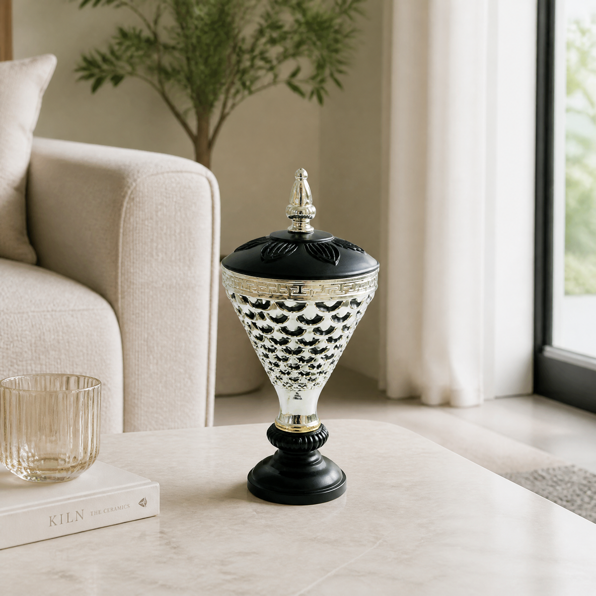 Black and silver lidded decorative burner on a pedestal base with a lattice pattern