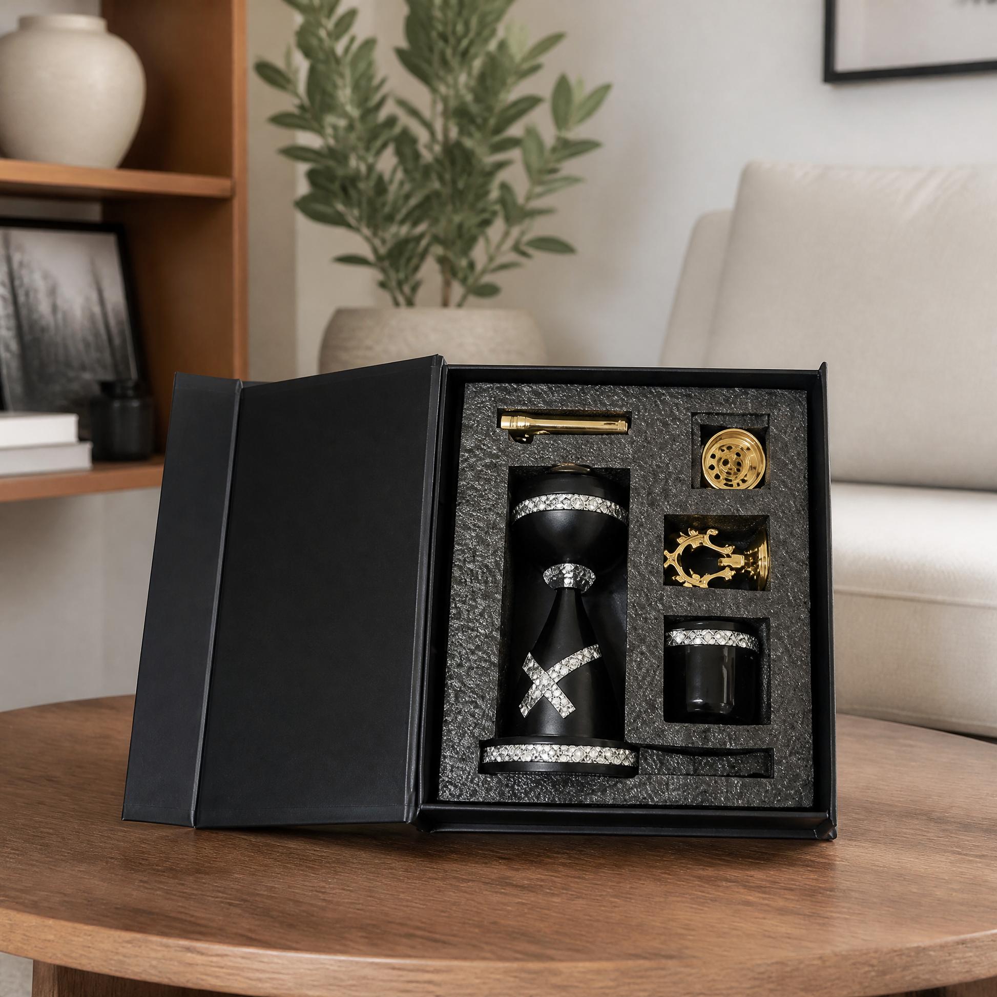 Black and gold boxed burner gift set open on a wooden table in a living room