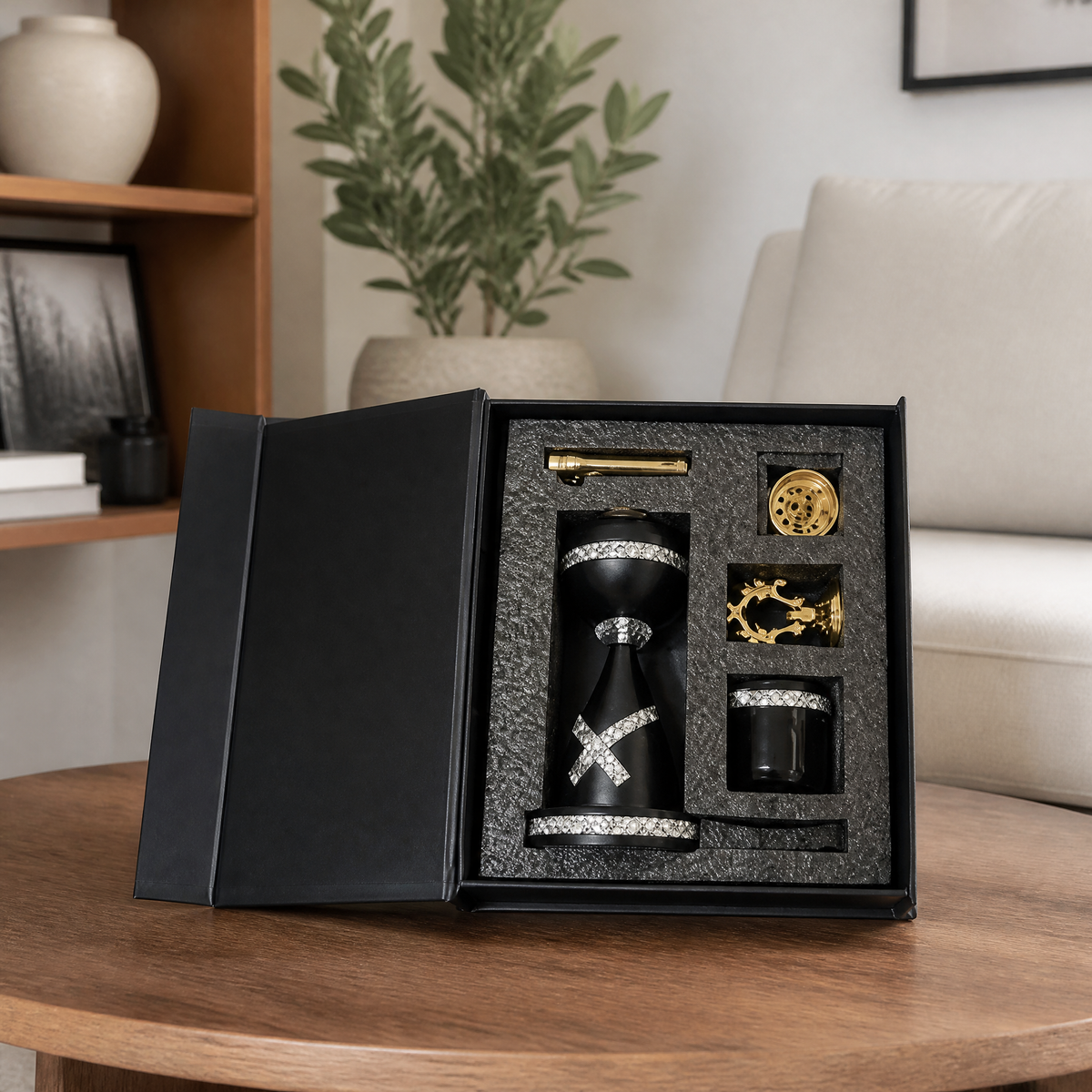 Black and gold boxed burner gift set open on a wooden table in a living room