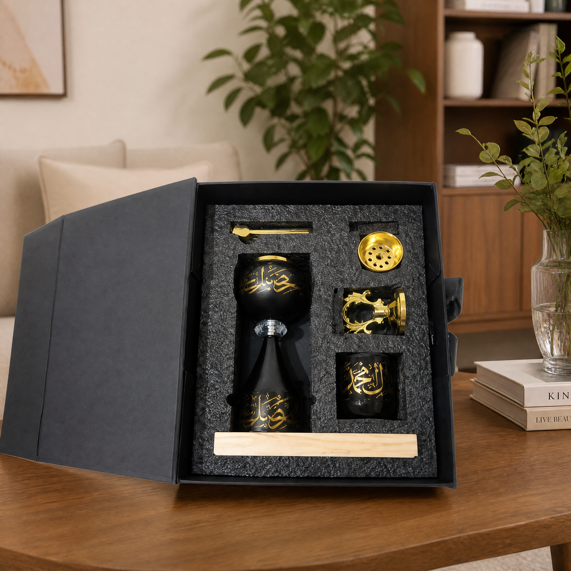 Black and gold burner gift set with cup and accessory pieces in an open gift box