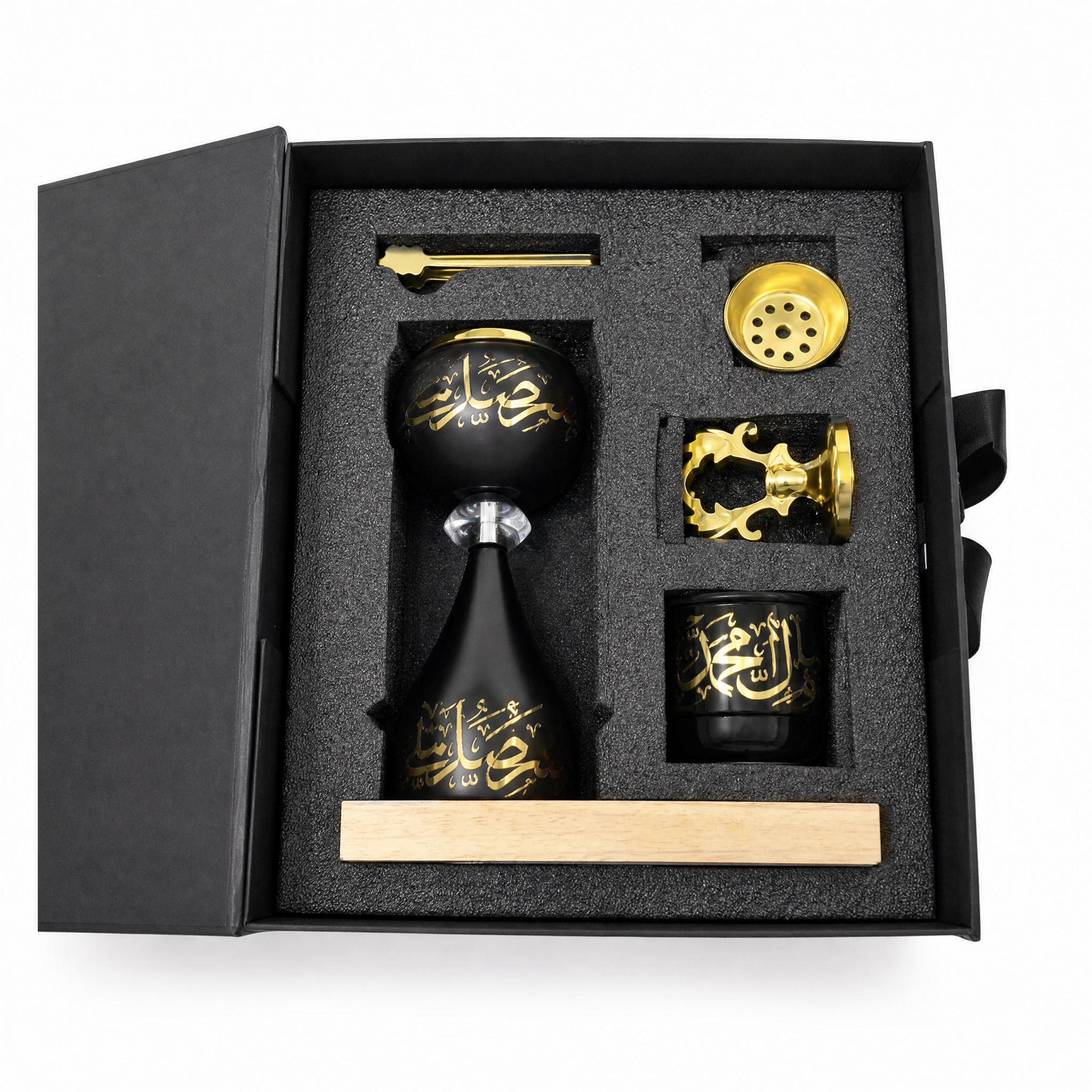 Black and gold burner gift set with cup and accessory pieces in an open gift box