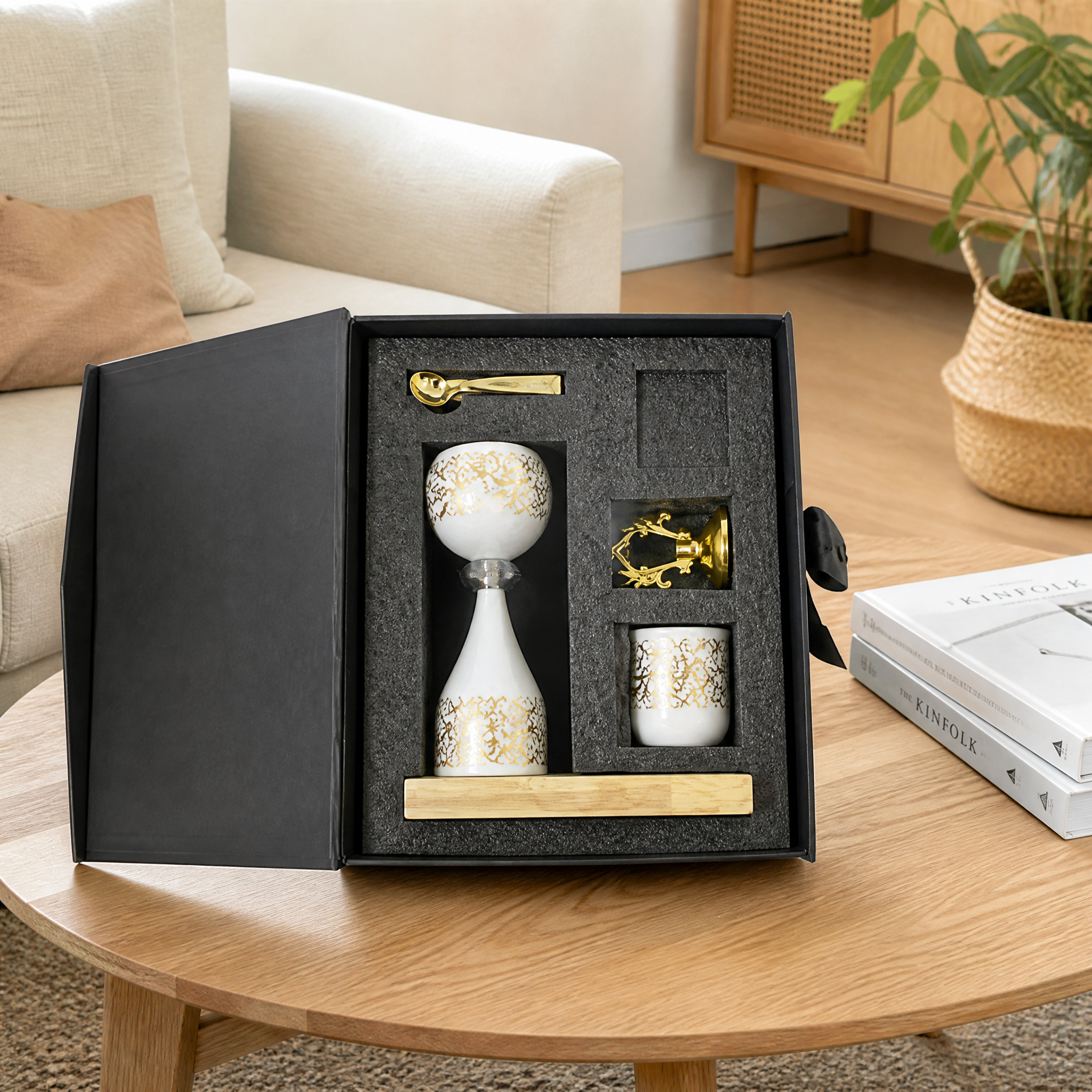 White and gold boxed burner gift set open on a round wooden table