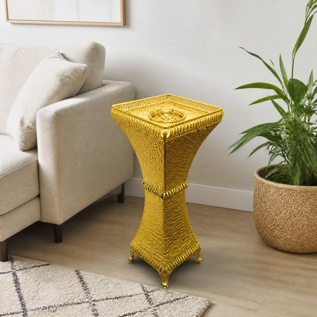 Gold-tone textured floor-standing burner on a wood floor beside a beige sofa in a living room