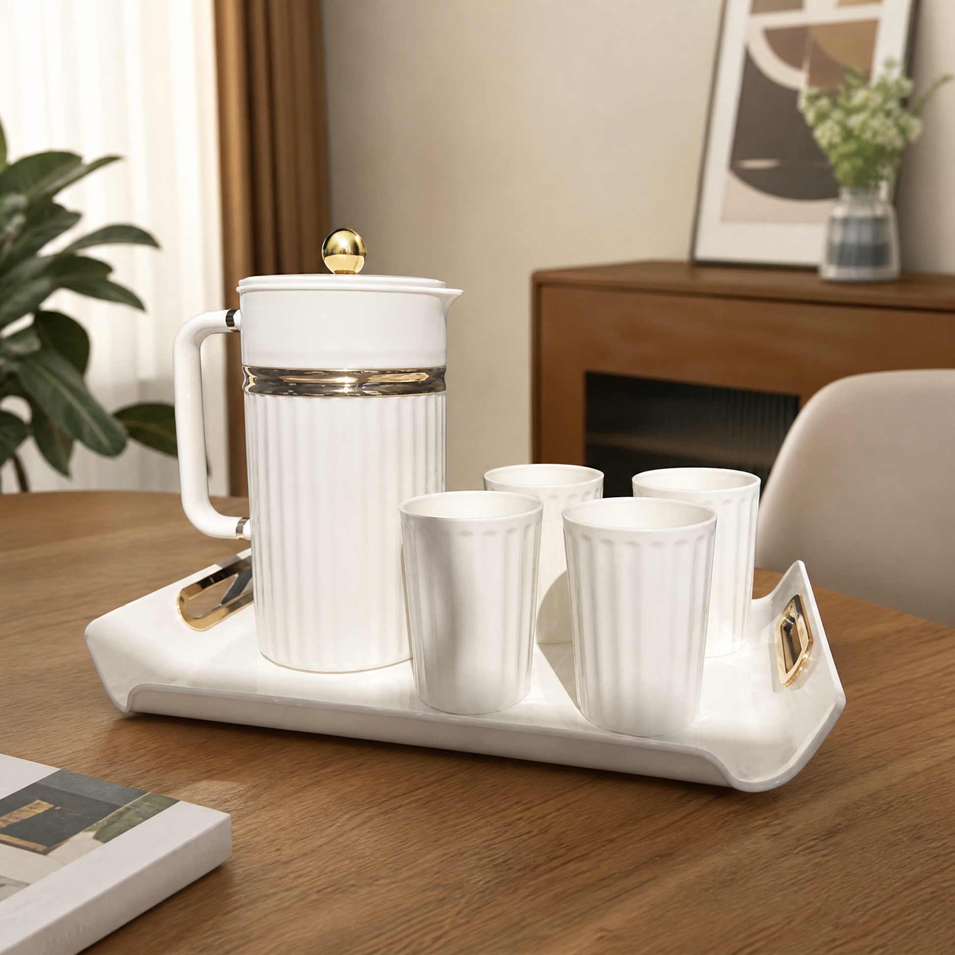 White and gold pitcher and cup serving set on its tray on a wooden table in a living room