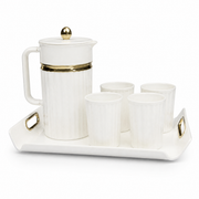 White ribbed pitcher with gold band and lid finial, four matching cups, on a white gold-handled tray