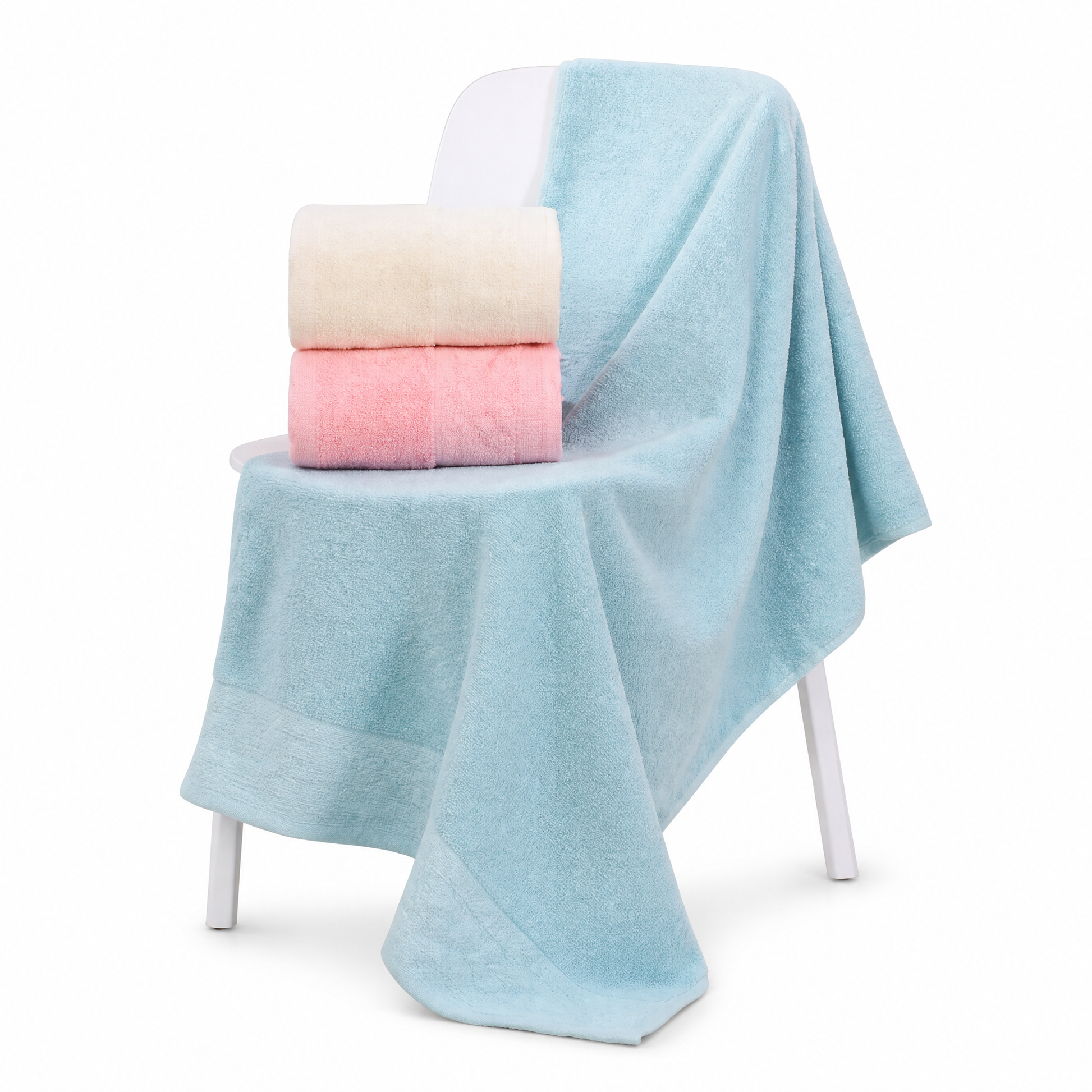 Light blue bath towel over a white chair with cream and pink towels folded on the seat