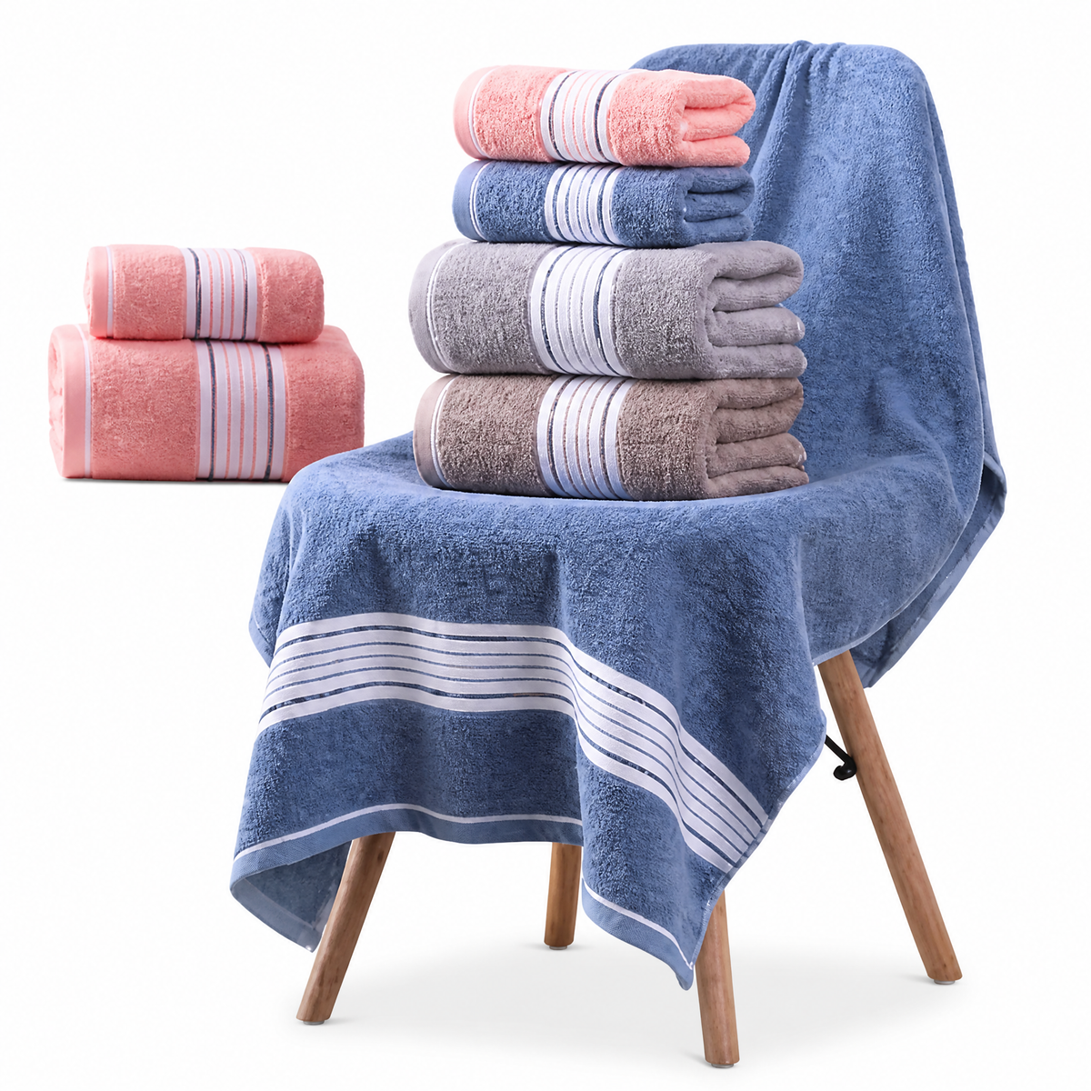 Blue striped-border bath towel on a chair with pink, blue, grey and taupe towels stacked