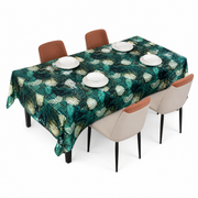Deep teal table covering printed with cream-white flowers, draped over a rectangular dining table